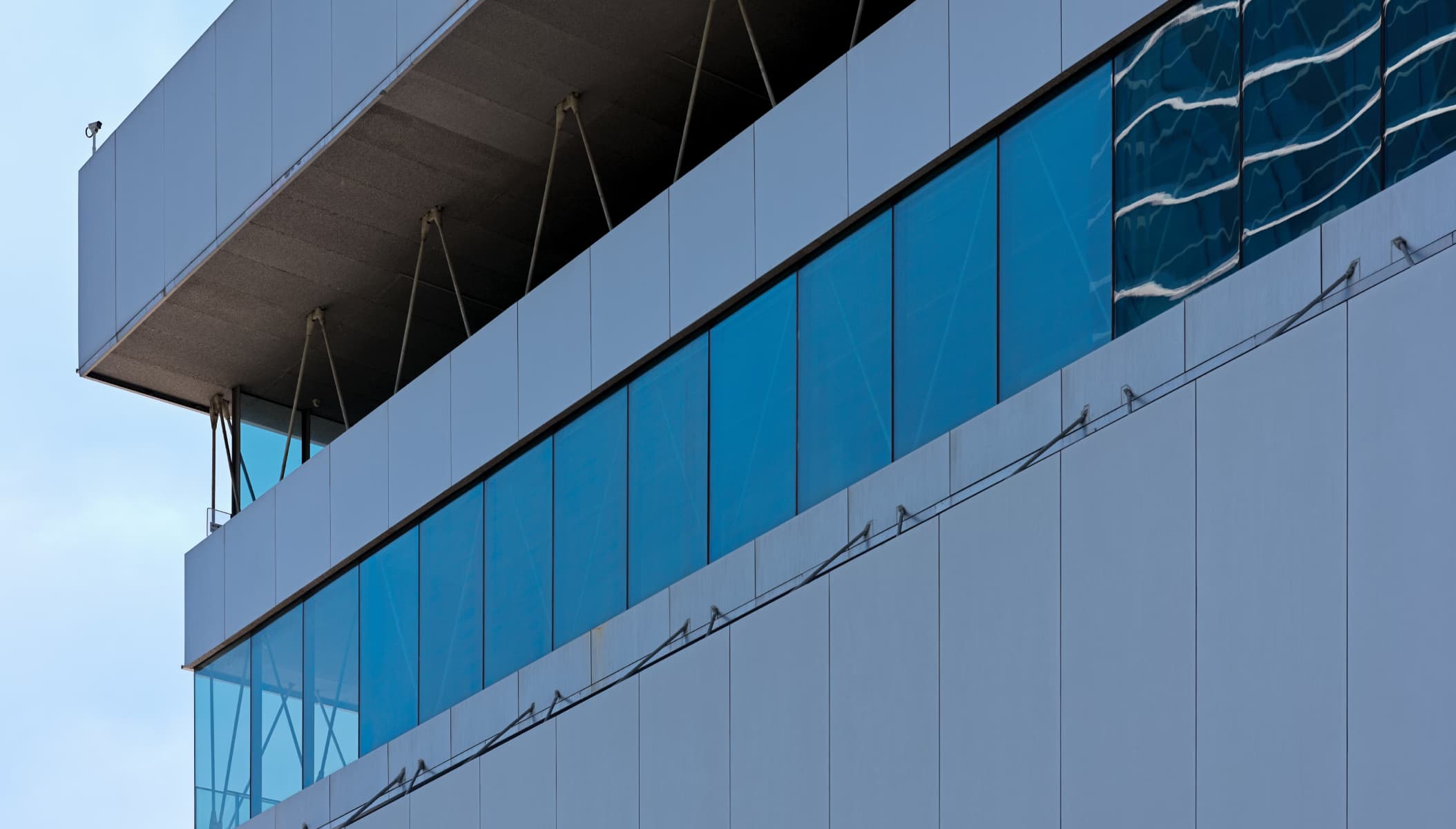 Modern blue building exterior representing Care Atlas professional consultancy